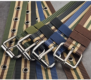 Detailed view of four striped canvas belts with metal buckles in green, black, blue and brown