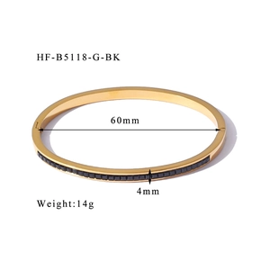 Detail view of gold-plated bangle featuring black square zircon stones and 4mm width