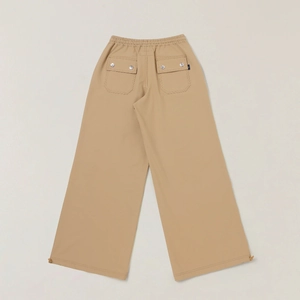 Detail view of khaki wide-leg pants featuring rear patch pockets with metal snaps