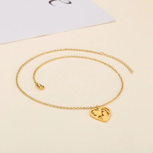 Golden heart necklace featuring a mother and child cutout pendant on a minimalist background