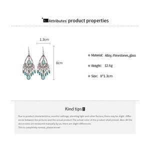 Detailed view of bohemian teardrop earrings with blue stones and silver alloy base
