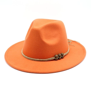 Detailed view of orange wool fedora featuring beige braided rope and bronze beads