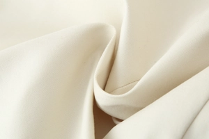 Detailed macro shot showing the beige twill fabric texture and soft woven material structure