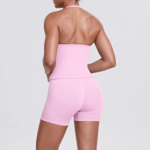 Rear view of pink yoga set featuring high-waisted peach lift shorts and a backless halter top