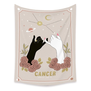 Close-up of bohemian Cancer zodiac tapestry with pink roses and golden astrology symbols