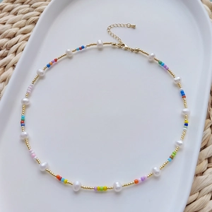 Close-up of a colorful beaded pearl necklace with irregular pearls and lobster clasp