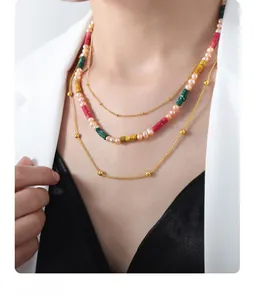 Close-up of layered necklace with freshwater pearls and colorful stone beads on a model