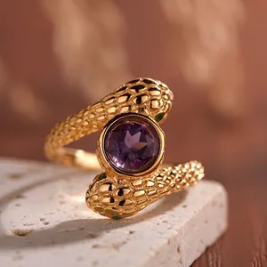 Macro detail of S925 silver serpent ring with purple amethyst and gold finish