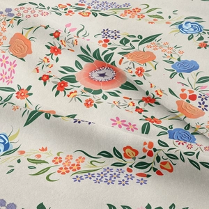 Close-up of beige bohemian tapestry showing intricate floral patterns and cotton linen texture