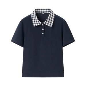 Detail of navy knit polo shirt with black and white plaid collar and flower buttons