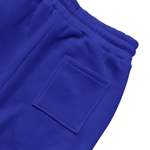 Detail showing elastic waistband and back pocket of blue men's knitted jogger pants