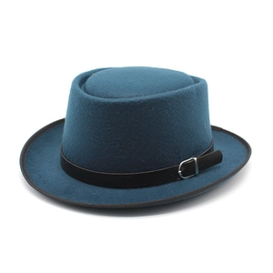 Detail of teal wool felt pork pie hat with black leather band and silver buckle