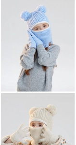 Detail of kids winter knit balaclava hat and matching gloves with fluffy pom-poms