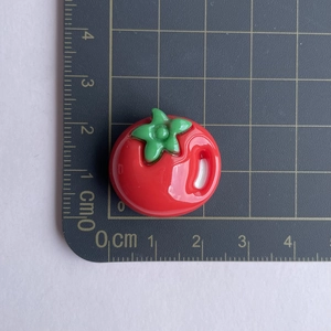Detailed top view of a red resin tomato charm showing 1.5cm size measurement