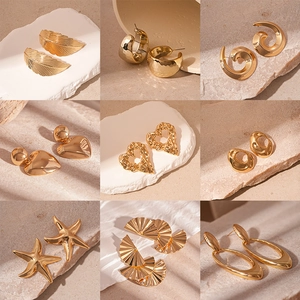Set of minimalist geometric gold stud earrings in heart star and feather shapes