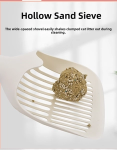 Detail of white cat litter scoop with large hollow grid showing clumping litter separation