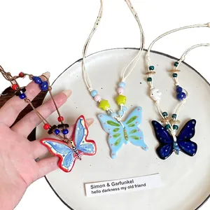 Vintage ceramic butterfly tassel necklaces with woven ropes in a three-piece jewelry set