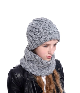 Close-up of grey chunky knit beanie and scarf set featuring diamond pattern texture