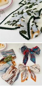 Detail of pleated silk scarf with floral patterns and micro accordion texture finish