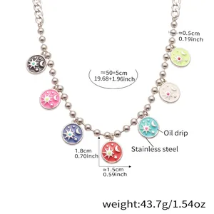 Detailed macro of stainless steel ball chain necklace with colorful enamel celestial pendants