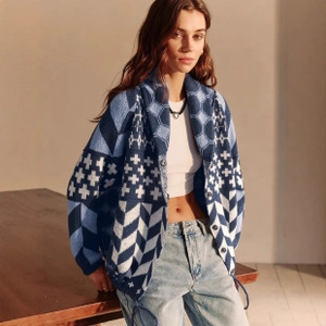 Detail of blue and white geometric knit cardigan with vintage pattern and soft texture