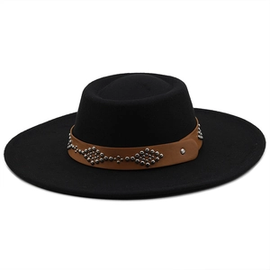 Close-up of wide-brim black wool hat with brown leather belt and silver metal rivets