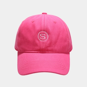 Close-up of white S-letter embroidery on a bright pink cotton twill baseball cap