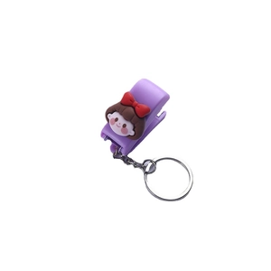 Cute purple cartoon nail clipper keychain with a girl figure on a white background