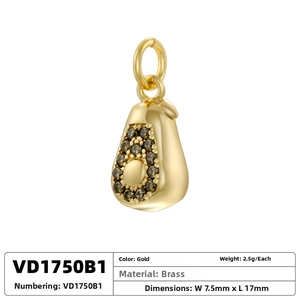 Macro detail of avocado-shaped brass pendant with green gemstone and technical dimensions