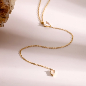 Elegant gold stainless steel necklace featuring dual teardrop crystal pendants for women