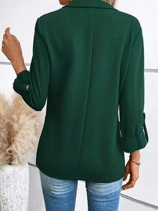 Rear view detail of a dark green tailored women's blazer with clean minimalist lines