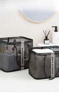 Detail of black mesh bath storage baskets in two sizes with vertical gray straps