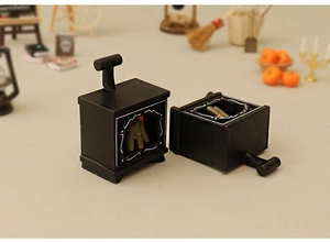 Macro view of miniature black antique fireplaces with faux wood for dollhouse decor
