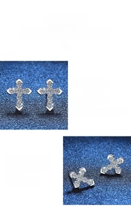 Macro shot of S925 sterling silver cross stud earrings with pavé moissanite detailing