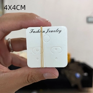 Close-up of 4x4cm white cardboard jewelry display cards for earrings and necklaces
