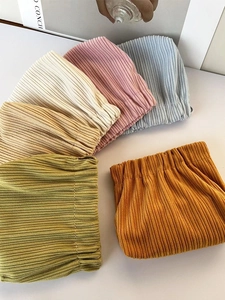 Colorful corduroy squeeze top cosmetic bags in mustard, green, and pink for small storage