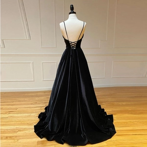Elegant black velvet backless evening gown with lace-up detail and long flowing train