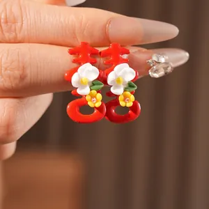 Red Xi character wedding earrings with small white flowers in New Chinese style
