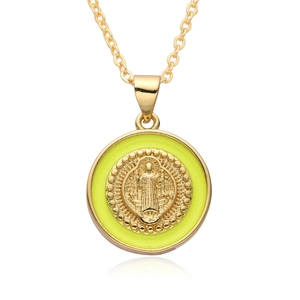 Close-up of golden necklace with a religious relief icon on a vibrant green enamel pendant