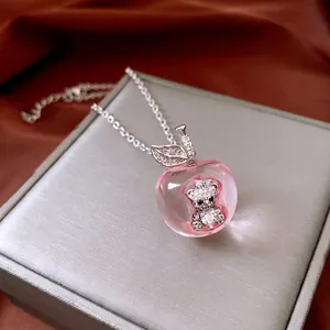 Elegant silver apple pendant necklace with pink resin and diamond bear interior charm
