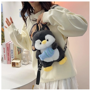Plush penguin backpack with adjustable straps showing cute penguin holding a small blue fish