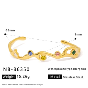 Detail of wavy golden stainless steel bangle with colorful cubic zirconia and dimensions