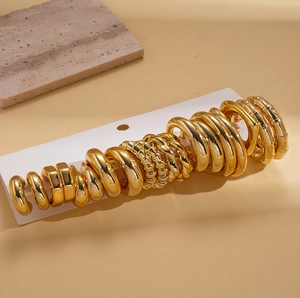 Detailed set of 20 pairs of gold hoop earrings featuring smooth, wavy, and twisted textures