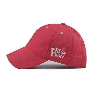 Detail of red cotton baseball cap with fresh fruit embroidery and white eyelets