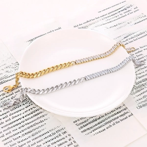 Detail view of gold and silver cuban link and zircon tennis chain bracelets on a book