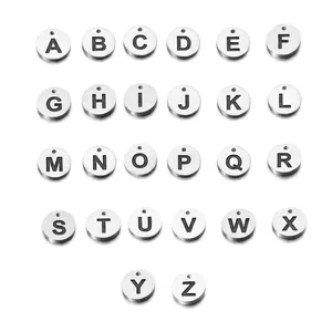 Macro shot of 26-piece stainless steel 12mm round letter charms set with bold engraving