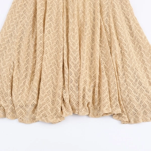 Elegant apricot knit maxi dress featuring a hollow mesh texture and a flared hemline