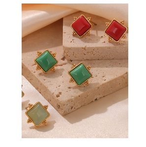 Detailed close-up of square geometric earrings with colorful natural stones and gold frame