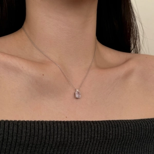 Close-up of a s925 silver necklace featuring a rectangular pink purple zircon pendant