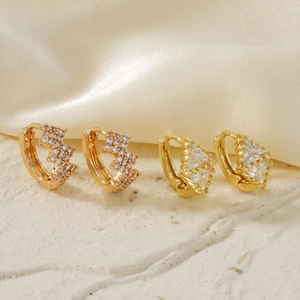 Elegant gold zircon earrings featuring unique wavy and rhombus designs on silk fabric